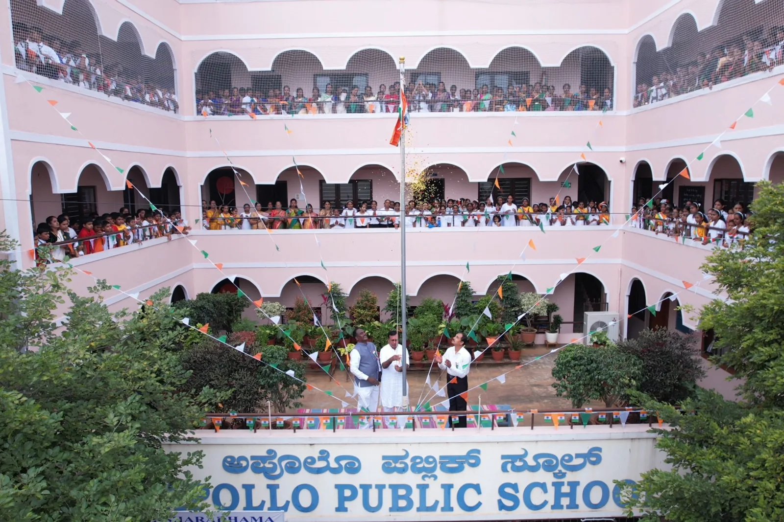 Students and staff gathered in the school courtyard for Independence Day flag hoisting