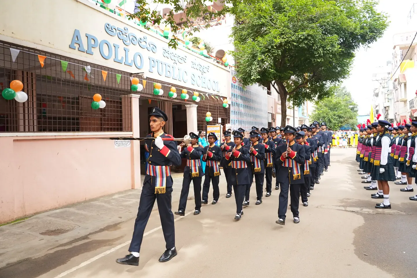 Student cadets marching in formation on the road outside the school