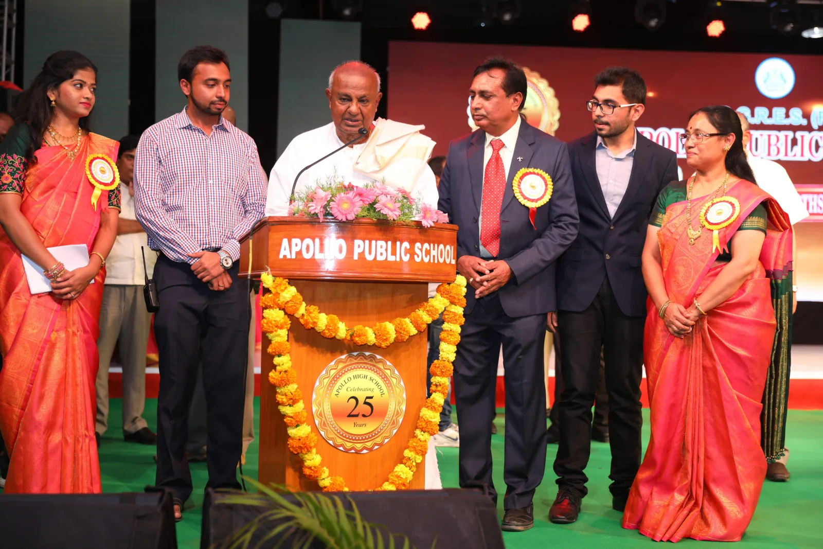 School management and guests of honour standing together on stage