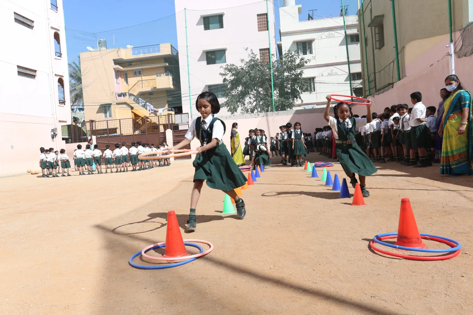 A student running between cones during a relay race