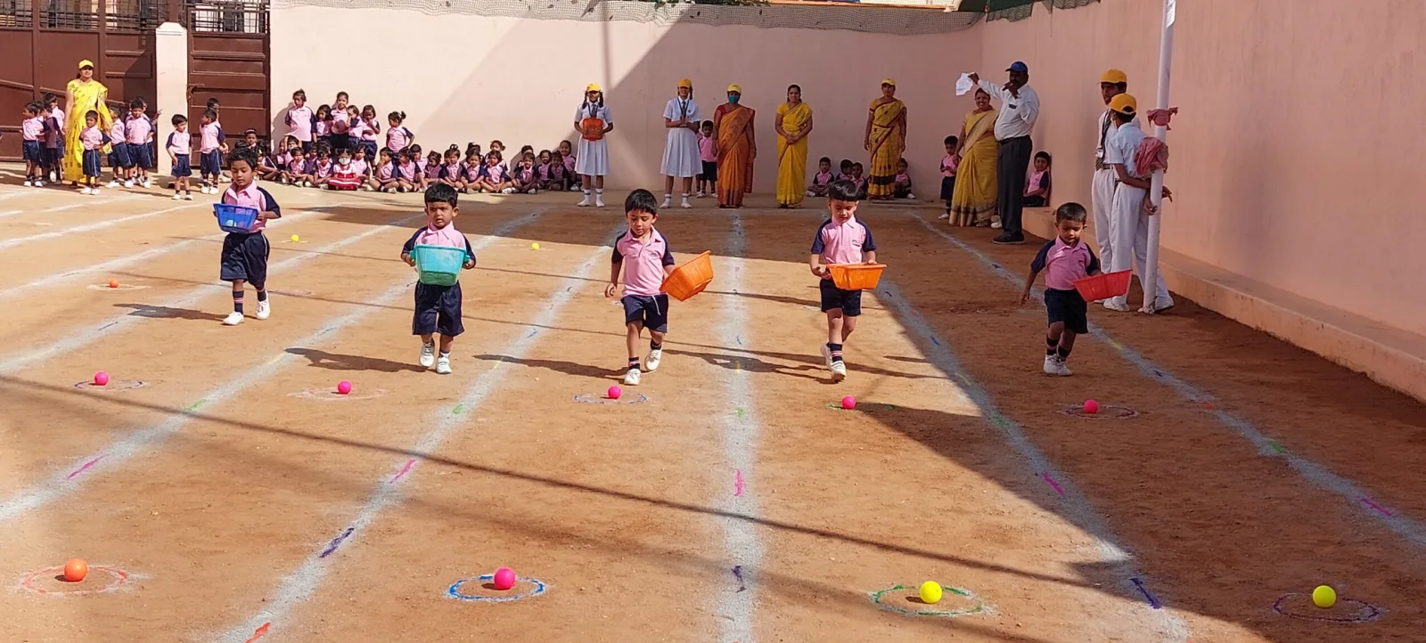 Young students running a relay race on a marked track